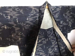 Japanese Kimono, very fine indigo color. I believe the fabric is ramie. It is an Ikat called Katsuri.  

Excellent condition even though it is old.  There is one patch which  ...