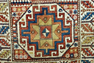 Kazak, Moghan area, 1880's. 
Five octagons with Memling Guls and stars of Salomon. 
Zoroastic Shamdan Mashaal borders with white ground. 
And granulated borders. 
Corroding in the black color. 
worn with old repairs.  ...