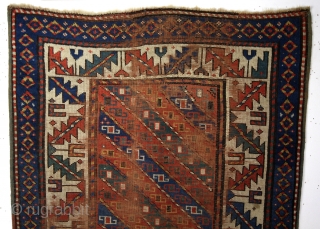 Caucasus, Kuba area, early 20th century. 
170 x 100 Cm. Wool on wool. 
Gracefully fading away in time. 
Zoroastic symbols in the border. 
'Barber pole' stripes with swastica's, solar symbols.   