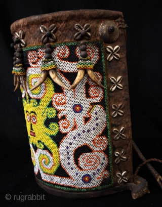 Dayak baby carrier. 
Glass beads, bark, leather and wood. 
high 36 Cm. wide 30 Cm. deep 17 Cm. 
              