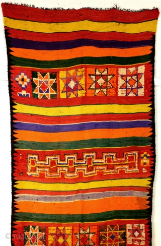 Morocco, Bedouins from the South who adapted the arabic customs.
Loom woven like a kilim but different from Iranian of Turkish kilims. 
Much thicker, very thick wool threads on black goat wool warp  ...