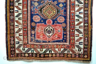 Iconic Shirvan, late 19th century. Mazdaism all over, the red medaillons are the winged God Farouvar of Mazda protecting the rug. 
In the border on the white ground vure and fire toartch.  ...