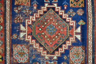 Iconic Shirvan, late 19th century. Mazdaism all over, the red medaillons are the winged God Farouvar of Mazda protecting the rug. 
In the border on the white ground vure and fire toartch.  ...