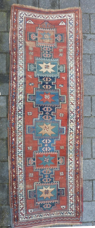 Antique NW-Persian/ Caucasian runner, 312  x 105 cm., 10'3" x 3'5" on woolen ground. With some wear and with all natural dyes. One older repair ( see pict. 3). Washed.  