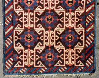 Lovely and unusual antique Kuba(?)Caucasian small poshti (?) rug, 95x62 cm.,ca. 1900, with multiple kufic border elements used as field design. Woven on woolen warps with brown woolen wefts. It has a  ...