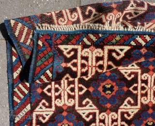 Lovely and unusual antique Kuba(?)Caucasian small poshti (?) rug, 95x62 cm.,ca. 1900, with multiple kufic border elements used as field design. Woven on woolen warps with brown woolen wefts. It has a  ...
