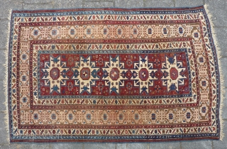 Antique Kuba Lesghi with Kufic border, 204  x 131 cm., 6'8" x 4'4", ca. 1900. Good pile with corroded browns and some scattered wear. In the center three repaired slits and  ...