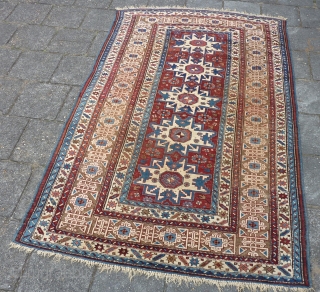 Antique Kuba Lesghi with Kufic border, 204  x 131 cm., 6'8" x 4'4", ca. 1900. Good pile with corroded browns and some scattered wear. In the center three repaired slits and  ...