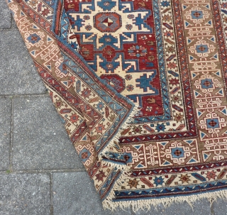 Antique Kuba Lesghi with Kufic border, 204  x 131 cm., 6'8" x 4'4", ca. 1900. Good pile with corroded browns and some scattered wear. In the center three repaired slits and  ...