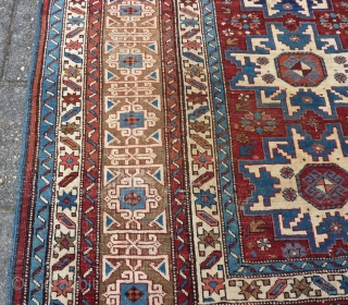 Antique Kuba Lesghi with Kufic border, 204  x 131 cm., 6'8" x 4'4", ca. 1900. Good pile with corroded browns and some scattered wear. In the center three repaired slits and  ...