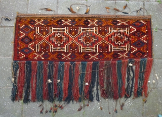 Kizil Ayak(?)Torba with a genuine shamanistic touch by attached pieces of rabbit(?)skin to the fringe. Ca. 1920s. Very good condition and pile. In my opinion all natural dyes, except probably for a  ...