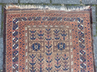 Baluch, 132  x 86 cm., 4' 4" x 2' 10", 19th c. with rare design(ensi inspired?). Low pile, frayed endings and a side. Natural dyes and a few green silk knots. 
