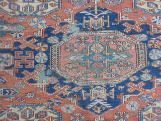 Dated Kuba Sumakh 1877 ( 1294 ), 280 x 198 cm., 9' 2" x  6' 6". With patches, damages and lots of joyfully used faded early fuchsine dye.    