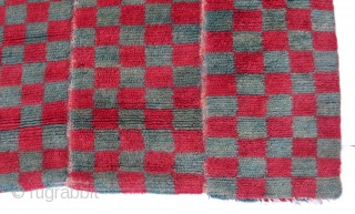 Tsukdruk Red & Green Checkered Khaden (TC01) 
31 1/2” x 63 1/4” 
Cut-pile checkered tsukdruk Khaden (sleeping size) Carpet 
3 panels of red & green checked design.
Condition: Well used but solid condition.  ...