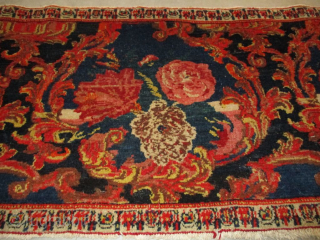 This circa 1910 Senna Sampler #8156 measures 1’9” X 3’6”. It has roses on a dark blue ground in various shades of red, pink,and ivory. It has very decorative vine work in  ...