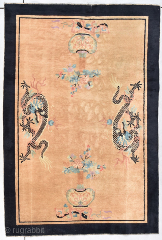 This late 19th century Peking Chinese Oriental Rug #8048 measures 5’3” X 7’11”. It has a sand colored background containing 2 facing dragons. Their scales are done in black. They have white  ...