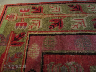 This circa 1920 Khotan #8151 handmade wool Oriental rug measures 8’1” X 5’0”. It has a depiction of four urns. Two urns are in pink, one in very pale green and one  ...