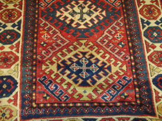 This third quarter 19th century antique Kazak-Gengi runner #8088 measures 3’1” X 10’9”. It has a tomato red ground with 8 ½ hooked medallions going up the center in yellow, green, mustard,  ...