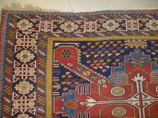 This circa 1880 Shirvan/Kuba #7995 measures 4’7” X 6’4”. It has three tomato red Saint Andrews crosses on an indigo ground. The ground is covered in quartered octagons in ivory, tobacco, two  ...
