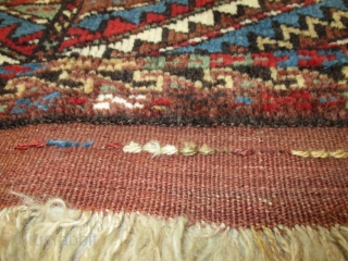 This late 19th early 20th century antique Turkomen rug #8096 probably Yomud or Afghan measures 1’4” X 2’4”. It has a single medallion in the center of the rug in red, ivory,  ...