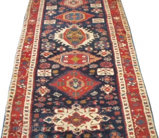 This circa 1850 antique Karadan Kazak Oriental rug runner #6453 measures 3’8” X 13’6”. It has eleven different shaped, sized and colored medallions on a dark blue field with a rust border  ...