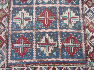 #6423 Shirvan Antique Caucasian Rug This circa 1870 Shirvan antique Oriental rug measures 4’0’ X 6’0’. It has fifteen panels with red and white medallions containing cross bars of ivory/blue , ivory/red  ...