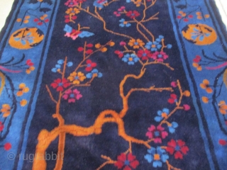 This circa 1900 antique Peking Chinese handmade Oriental rug measures 2’8” X 6’7”. It has a navy blue ground containing two swimming ducks on a water feature out of which are growing  ...