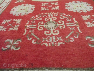 This circa 1900 Khotan Antique Oriental Rug measures 4’0” X 6’5”. It has a center medallion consisting of an eight pointed star outlined in Khotan pink. The upper and lower corners of  ...