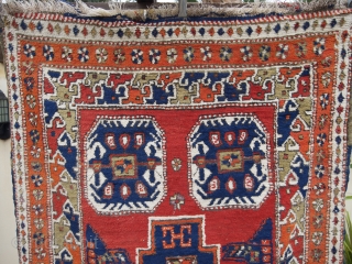 An East Anatolian village rug, (7.6ft x 3.5ft.) with distinctive Caucasian characteristics with a Kuba-Konagkend stepped medallion, framed by a stylised bird border. Two amulet motifs placed a-symmetrically at each end. Around  ...