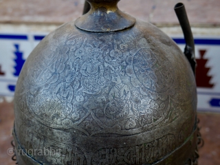 An antique Indo-Persian Helmet (Khula Khud) 19 th. century, Quajar. The front with nose shield and plume holders. Finely engraved with seated mediators and Islamic Galligraphy. length: 40 cm (with chain) diameter  ...