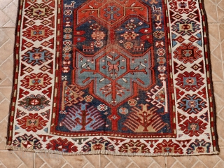 Antique Kazak rug, 108 x 196 cm. late 19 th. century. Unusual stylised wing design. Dark brown colour corroded and slightly reduced at both ends.        