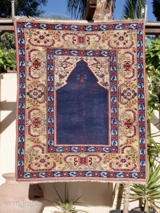 A fine and accurate reproduction of a 17 th. century "Transylvanian" prayer rug.  West Anatolian. 125 x 120 cm. The prayer niche with arabesque spandrels and a mustard yellow main border  ...