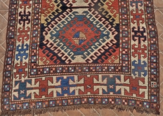 Kazak Rug, Bordjalou region, SE Caucasus, 215 x 11 cm. (7.05ft x 3.7ft) Probably 3 rd. qtr. of 19 th century. The design with a column of latch-hooked diamonds on a dark  ...