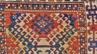 Kazak Rug, Bordjalou region, SE Caucasus, 215 x 11 cm. (7.05ft x 3.7ft) Probably 3 rd. qtr. of 19 th century. The design with a column of latch-hooked diamonds on a dark  ...