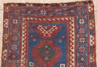Bordjalou Kazak 215 x 112 cm (7.05ft x 3.7ft) with pre -1900 liveliness. The design with hooked diamonds and medallions on an abrashed blue ground. The field with animals, combs, herding sticks  ...
