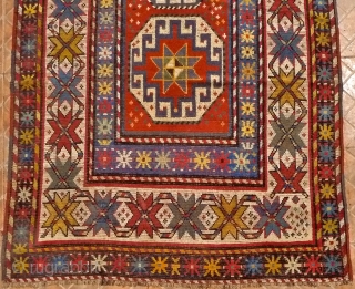 Genje- Moghan long rug,  10ft x 3.9ft (305 cm x 120 cm.) Late 19 th. century.. The design with a single, vertical row of Moghan Memling Guls. Attractice white ground border  ...