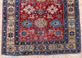 An Afshan Kuba Rug, 4.6ft x 3.2ft.  Circa 1910. The classic design with rows of triple rosettes spread across a burgundy red field.
Each rosette framed by a double latch-hook. A very  ...