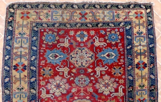 An Afshan Kuba Rug, 4.6ft x 3.2ft.  Circa 1910. The classic design with rows of triple rosettes spread across a burgundy red field.
Each rosette framed by a double latch-hook. A very  ...