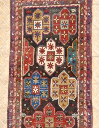 An Artsakh Karabagh long rug,( Nagorno Karabagh)  312 x  102 cm. Late 19th. century. 
 Dark chocolate brown ground with shield design with soft pastel tones: aquamarine, mauve, ocre, sea-green.  ...