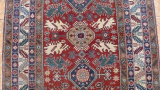 Antique Kuba 'Bird' Rug,  7.1ft x 4.9ft. Unusual type: The design with each floral medallion, flanked by four, highly stylised bird motifs in camel, ivory and sea-green Condition: slight overall, even  ...