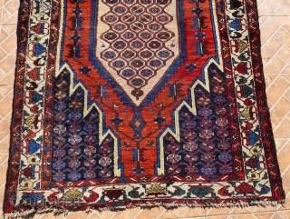 A Mazlaghan rug, cr. 1920, 6.5x4.2ft (198x129cm.)
 Very decorative piece with central honeycomb design and all the right colors incl. an abrashed madder-red field and soft yellow. Attractive white-ground tree border. In  ...