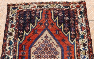 A Mazlaghan rug, cr. 1920, 6.5x4.2ft (198x129cm.)
 Very decorative piece with central honeycomb design and all the right colors incl. an abrashed madder-red field and soft yellow. Attractive white-ground tree border. In  ...