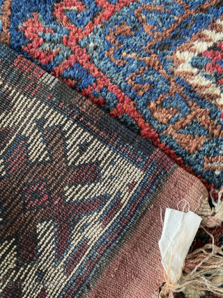 A finely woven tribal rug from Persian Kurdistan, likely from the Kolyai or Sanjabi weaving tradition in the Jaf-Kurdish style. The palette is rich with age-appropriate depth: indigo blues with natural abrash. ...