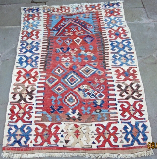 Folky West Anatolian prayer kelim depicting confronting zoomorphic figures in the mihrab, 19th century,
natural dyes, highlights of an intense red insect dye, metal brocading, excellent condition, 58" X 42"[148 X 107cm]  