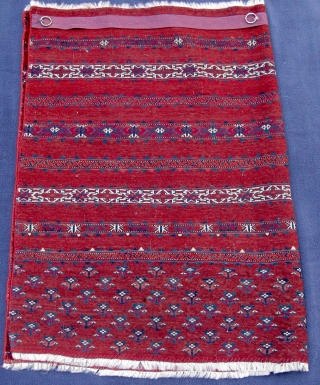 Rare finely woven Tekke Chuval, circa 1800 with areas of corrosive red insect dyes, ruby red silk, corrosive white cotton,
corrosive blue dye, 43" X 29"[110 X 74cms]      