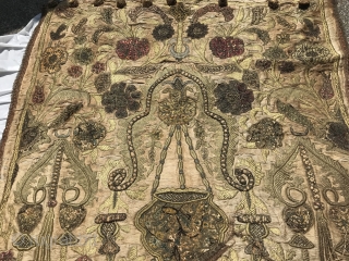 18th C. Turkish Prayer Niche Embroidery

Very dense metallic embroidery forming a prayer niche in center with hanging vessel. Bottom of niche with floral bouquet in vase. Thinner vase pillars go up along  ...