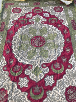 Late 19th C. Ottoman Turkish Wall Hanging.

Hand embroidered with silver metallic threads on red, green, and cream silk.
Center and corners have depiction of signature tugras.
Size:6’x10’. Backed with gold silk in excellent condition.
 