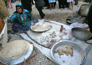 This is a sofreh aard (flour cloth) from the Kamo area of Central Iran measuring 4'6"X 4'10" = 138 x 148cm. The last picture shows my ex-wife making bread for the whole  ...