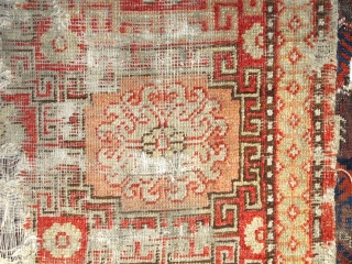 Khotan Rug, small format blossoms in lattice pattern with all natural colors. soft wool, evident wear and holes. Sourced recently in Tibet. 4"10' x 2'9" (146x81cm)       