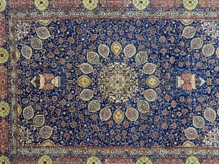A Tabriz carpet with an 'Ardabil Carpet' medallion design, set against a blue foundation and complemented by red and yellow patterns on blue borders, often represents a beautiful and intricate piece of  ...